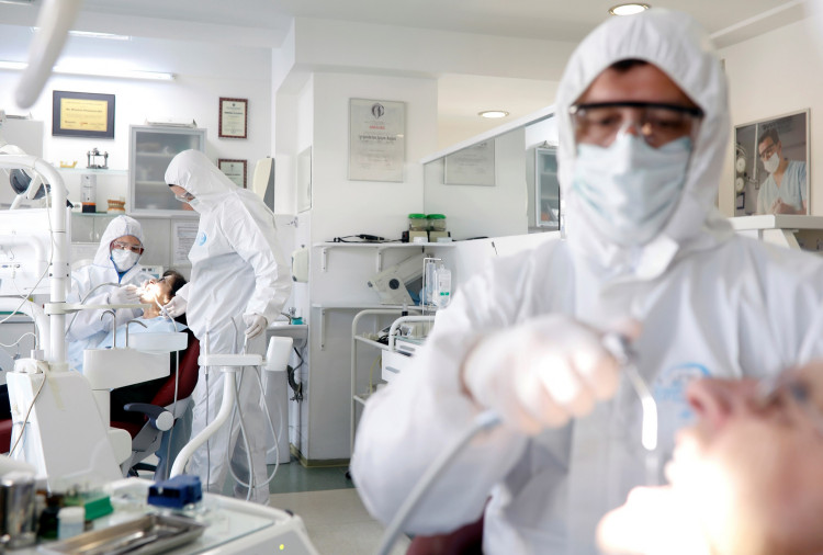 Doctor Marjan Stojanovski and his colleagues work only with patients with acute pain in protective suites due to coronavirus disease (COVID-19) protection measures in Skopje