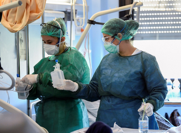 Medical staff wearing protective masks, glasses and suits treat a patient suffering from coronavirus disease (COVID-19) in an intensive care unit at the Oglio Po hospital