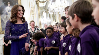 Catherine, Duchess of Cambridge, speaks with a school choir as she hosts a Gala Dinner in celebration of the 25th anniversary of Place2Be at Buckingham Palace, in London