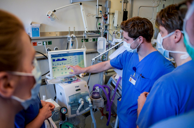 Doctors receive instructions for a respirator system at the intensive care unit of the University Medical Center Hamburg-Eppendorf in Hamburg, Germany