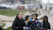 FILE PHOTO: United Nations High Commissioner for Refugees (UNHCR) Special Envoy Angelina Jolie reacts as it rains during a news conference during her visit to Syrian refugees in the Bekaa valley