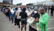 Shoppers queue outside a grocery store during a 21 day nationwide lockdown, aimed at limiting the spread of coronavirus disease (COVID-19) in Soweto