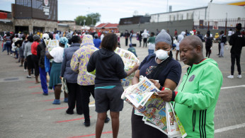 Shoppers queue outside a grocery store during a 21 day nationwide lockdown, aimed at limiting the spread of coronavirus disease (COVID-19) in Soweto
