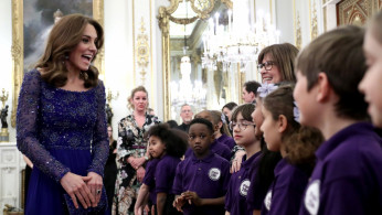 Catherine, Duchess of Cambridge, speaks with a school choir as she hosts a Gala Dinner in celebration of the 25th anniversary of Place2Be at Buckingham Palace, in London
