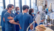 Doctors receive instructions for a respirator system at the intensive care unit of the University Medical Center Hamburg-Eppendorf in Hamburg