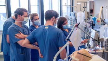 Doctors receive instructions for a respirator system at the intensive care unit of the University Medical Center Hamburg-Eppendorf in Hamburg