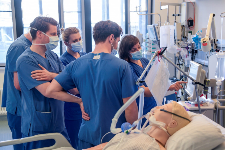 Doctors receive instructions for a respirator system at the intensive care unit of the University Medical Center Hamburg-Eppendorf in Hamburg