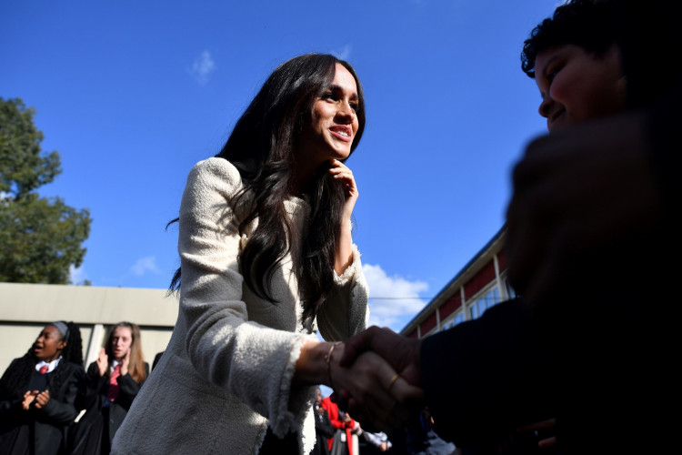 Britain's Meghan, Duchess of Sussex, smiles as she is welcomed by students to visit the Robert Clack School in Essex