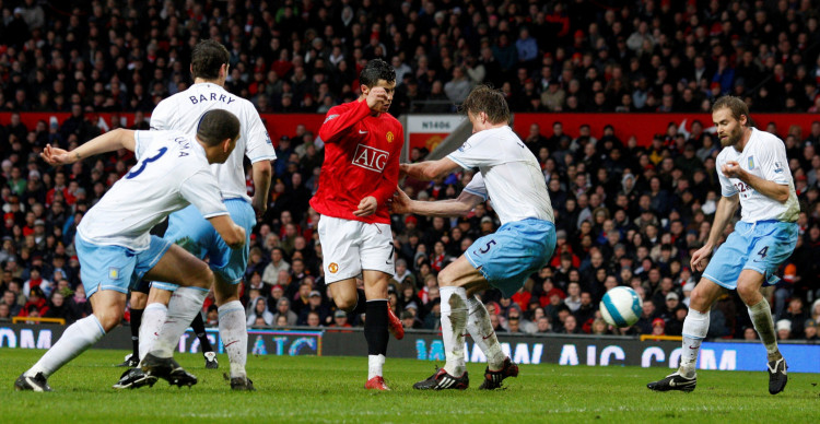 FILE PHOTO: Manchester United's Cristiano Ronaldo flicks the ball past the Aston Villa defence before scoring the opening goal in a 4-0 Premier League win at Old Trafford