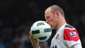 FILE PHOTO: Manchester United striker Wayne Rooney kisses the ball after scoring a hat-trick in a 4-2 Premier League victory over West Ham United at Upton Park