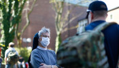 A sister welcomes people during a food distribution for the needy at the Cologne seminary, as the spread of the coronavirus disease (COVID-19) continues in Cologne, Germany