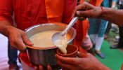 Members of All India Hindu Mahasabha serve a traditional drink with cow urine as an ingredient during a gaumutra (cow urine) party, which according to them helps in warding off coronavirus disease (COVID-19), in New Delhi