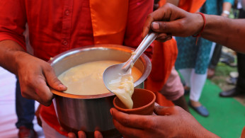 Members of All India Hindu Mahasabha serve a traditional drink with cow urine as an ingredient during a gaumutra (cow urine) party, which according to them helps in warding off coronavirus disease (COVID-19), in New Delhi