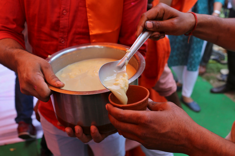Members of All India Hindu Mahasabha serve a traditional drink with cow urine as an ingredient during a gaumutra (cow urine) party, which according to them helps in warding off coronavirus disease (COVID-19), in New Delhi