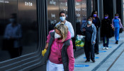 Health workers wait in line to get food near the Jacob K. Javits Convention Center, as the outbreak of the coronavirus disease (COVID-19) continues