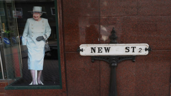 A cut-out image of Britain's Queen Elizabeth is seen on New Street