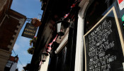 A message is seen written on a chalkboard in the window of The Prince Harry pub in Windsor while the spread of the coronavirus disease (COVID-19) continues