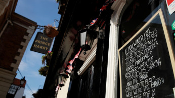 A message is seen written on a chalkboard in the window of The Prince Harry pub in Windsor while the spread of the coronavirus disease (COVID-19) continues