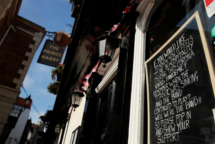 A message is seen written on a chalkboard in the window of The Prince Harry pub in Windsor while the spread of the coronavirus disease (COVID-19) continues