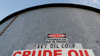 FILE PHOTO: FILE PHOTO: A sticker reads crude oil on the side of a storage tank in the Permian Basin