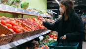 Woman in face mask shopping in the supermarket.