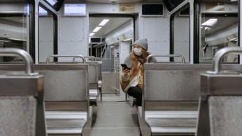 Woman wearing a mask on train. 