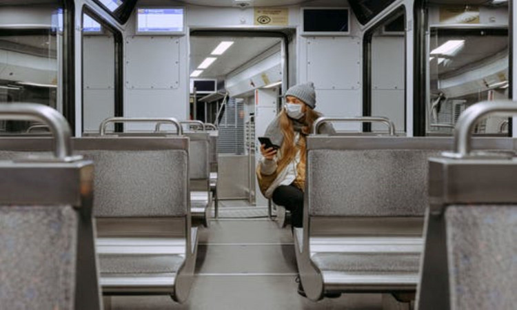 Woman wearing a mask on train. 