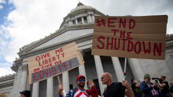 Protesters against the state's extended stay-at-home order demonstrate in Olympia