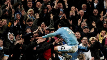 Manchester City forward Carlos Tevez celebrates with the fans