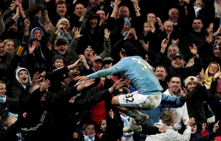 Manchester City forward Carlos Tevez celebrates with the fans
