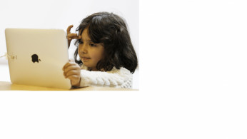 A girl views a new iPad tablet computer at an Apple store during its UK launch in central London May 28, 2010