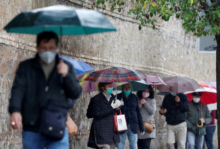 People queue to receive free protective masks that have been bought by evangelicals in China