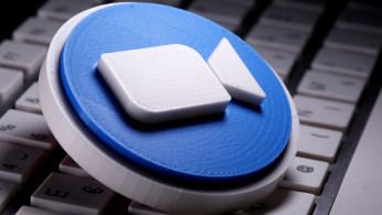 A 3D printed Zoom logo is placed on the keyboard in this illustration taken April 12, 2020. 