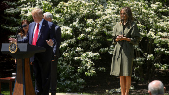 U.S. President Donald Trump and first lady Melania Trump hold a tree-planting ceremony outside the Oval Office on the 50th anniversary of Earth Day at the White House in Washington, U.S. April 22, 2020. REUTERS/Jonathan Ernst
