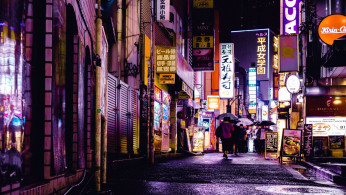 Woman walking on the streets during night time.