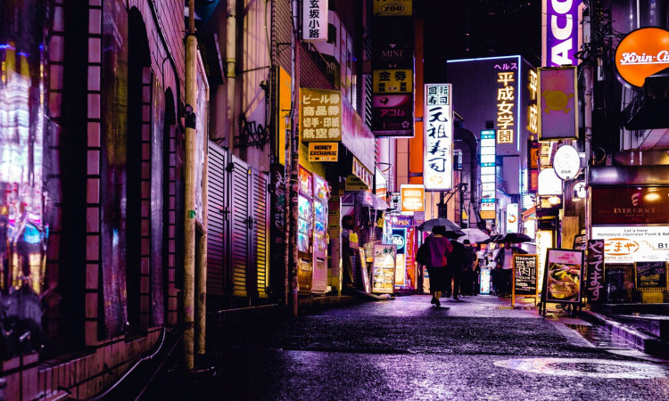Woman walking on the streets during night time.