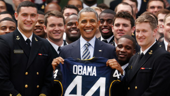 FILE PHOTO: U.S. President Barack Obama stands with a United States Naval Academy football jersey after presenting the Commander-in-Chief Trophy to the team in the Rose Garden at the White House in Washington.