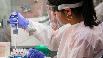 Scientists work in a lab testing COVID-19 samples at New York City's health department, during the outbreak of the coronavirus disease (COVID-19) in New York