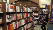 A woman reads a book at a Barnes & Noble bookstore in Pasadena, California November 26, 2013.