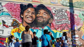 FILE PHOTO: Fans gather around a mural to pay respects to Kobe Bryant after a helicopter crash killed the retired basketball star