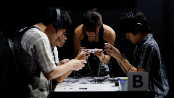 Visitors try a gaming program on Sony's Xperia smartphone at Tokyo Game Show 2019 in Chiba, east of Tokyo, Japan, September 12, 2019. 
