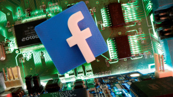 Facebook symbol is seen on a motherboard in this picture illustration