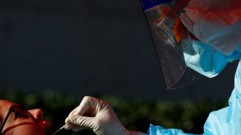 A foreign journalist gets tested for the coronavirus disease (COVID-19) before attending a news conference