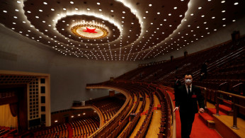 Security personnel inspect the venue at the end of the opening session of NPC in Beijing