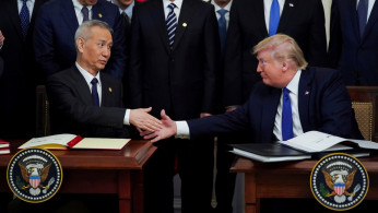 FILE PHOTO: Chinese Vice Premier Liu He and U.S. President Donald Trump shake hands after signing 