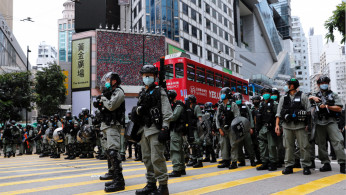 Hong Kong police stand at the ready during a protest in May.
