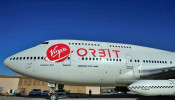 Richard Branson's Virgin Orbit, with a rocket underneath the wing of a modified Boeing 747 jetliner