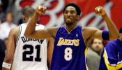 FILE PHOTO: Los Angeles Lakers guard Kobe Bryant celebrates while San Antonio Spurs forward Tim Duncan walks off disconsolately during Game 2 of the Western Conference Finals at the Alamodome in San Antonio