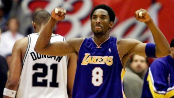 FILE PHOTO: Los Angeles Lakers guard Kobe Bryant celebrates while San Antonio Spurs forward Tim Duncan walks off disconsolately during Game 2 of the Western Conference Finals at the Alamodome in San Antonio