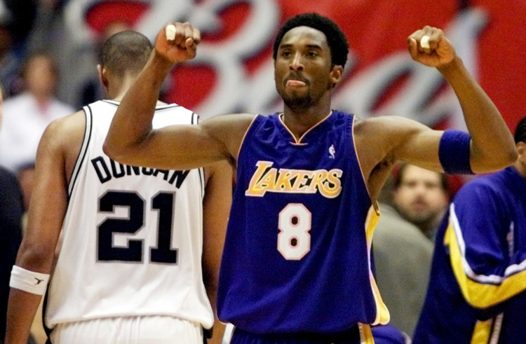 FILE PHOTO: Los Angeles Lakers guard Kobe Bryant celebrates while San Antonio Spurs forward Tim Duncan walks off disconsolately during Game 2 of the Western Conference Finals at the Alamodome in San Antonio